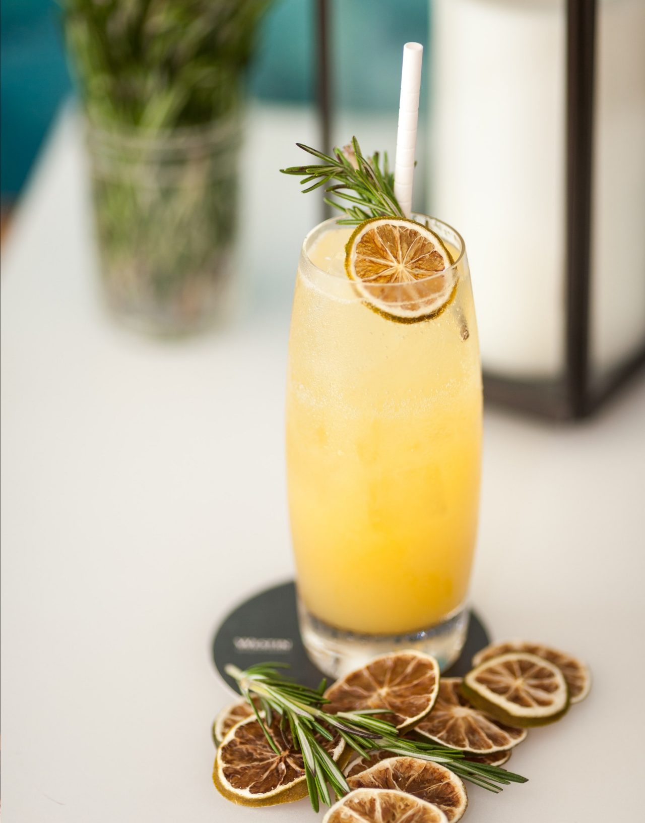 Yellow fruity cocktail with dried lemon garnish