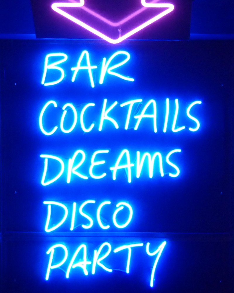 A sign that says bar, cocktails, dreams, disco, party
