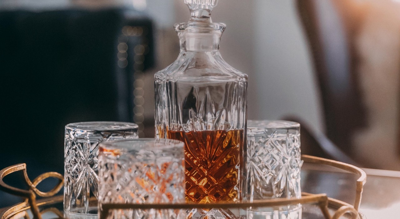 Whiskey in glass decanter with matching glasses