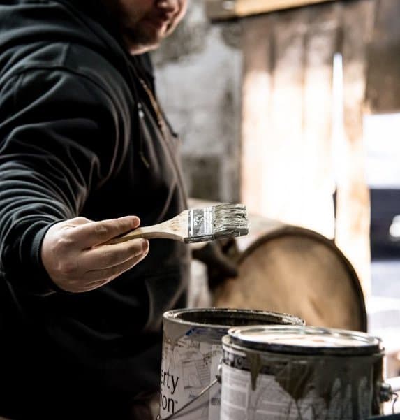 Painting oak barrels at Barton 1792 Distillery, Bardstown, Kentucky