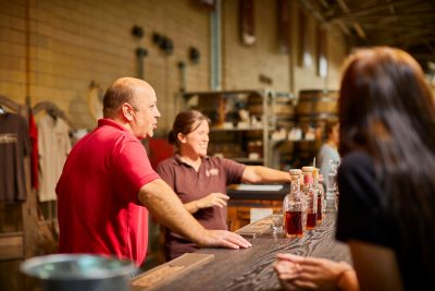 Male and female working at Gift shop counter at A. Smith Bowman Distillery