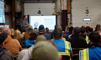 Employees at Boston Brands of Maine listening to a lecture