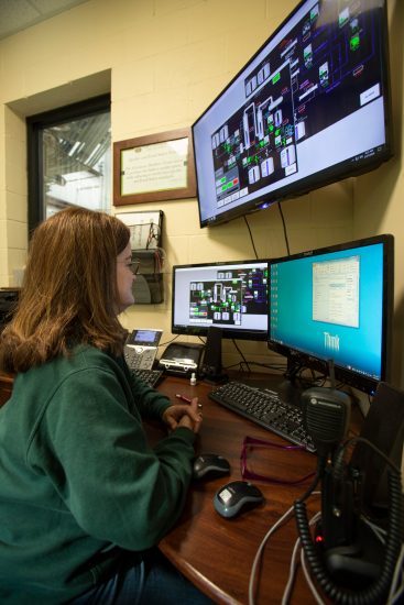 Female monitoring production at Glenmore Distillery