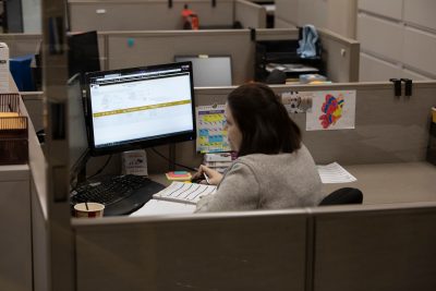 Woman working at computer in the office at Glenmore Distillery
