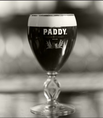 Black and white closeup of Irish Coffee in Paddy glass