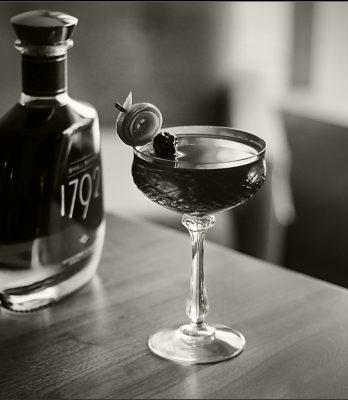 Black and white 1792 bottle and cocktail on table