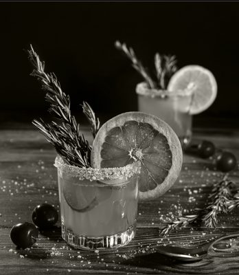Black and white cocktail with grapefruit rim and garnish