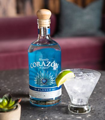 Corazon Blanco Tequila Bottle and cocktail on table