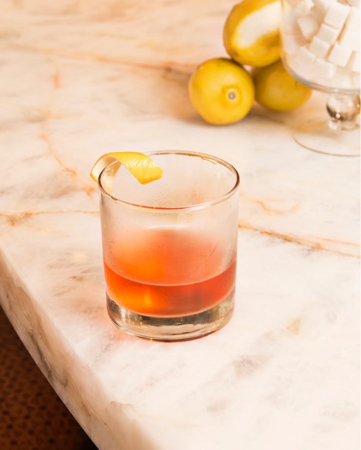 The Sazerac being served on a marble bar top