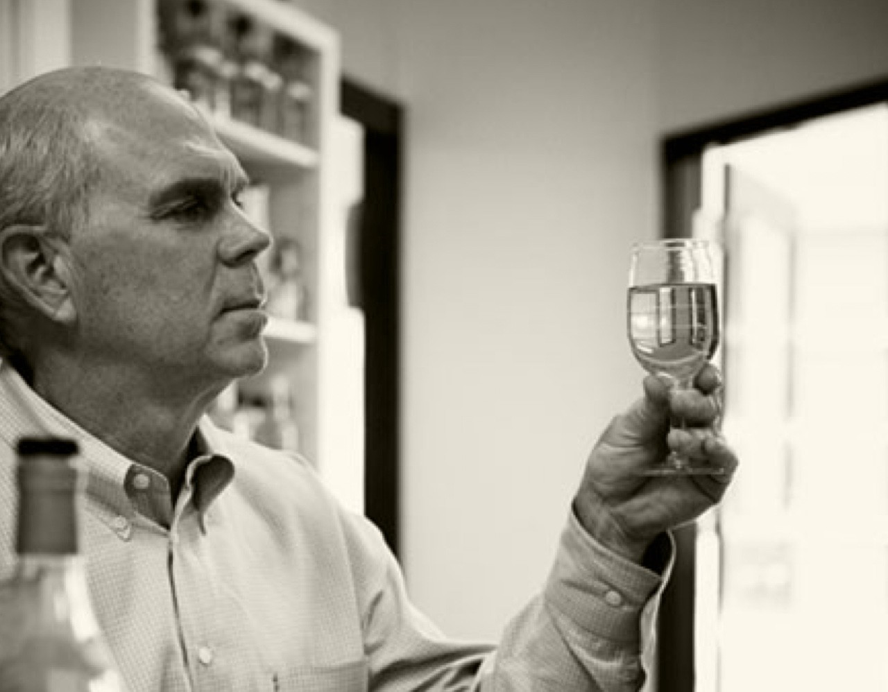 A man taste testing a glass of Van Winkle Bourbon