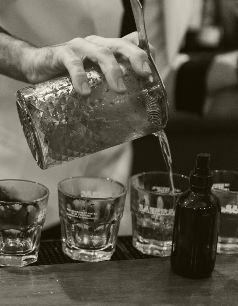 Chilled Sazerac Rye being poured into whiskey glasses for customers to taste