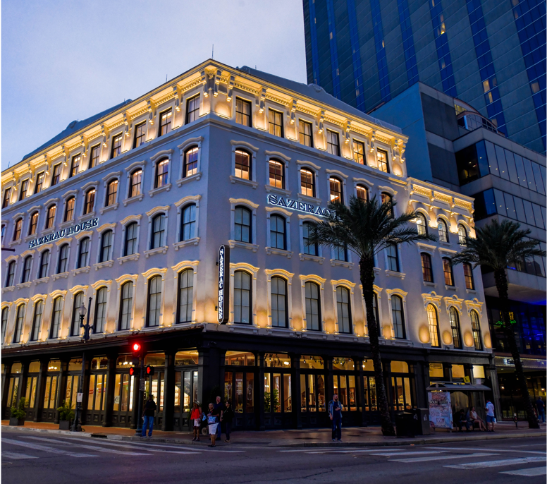 Front of Sazerac House lit up at dusk