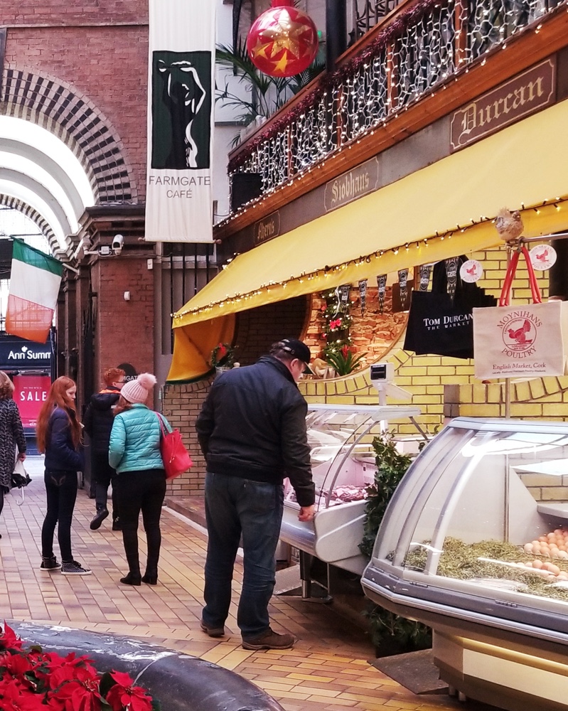 A customer picking out a meat at a street deli in Cork