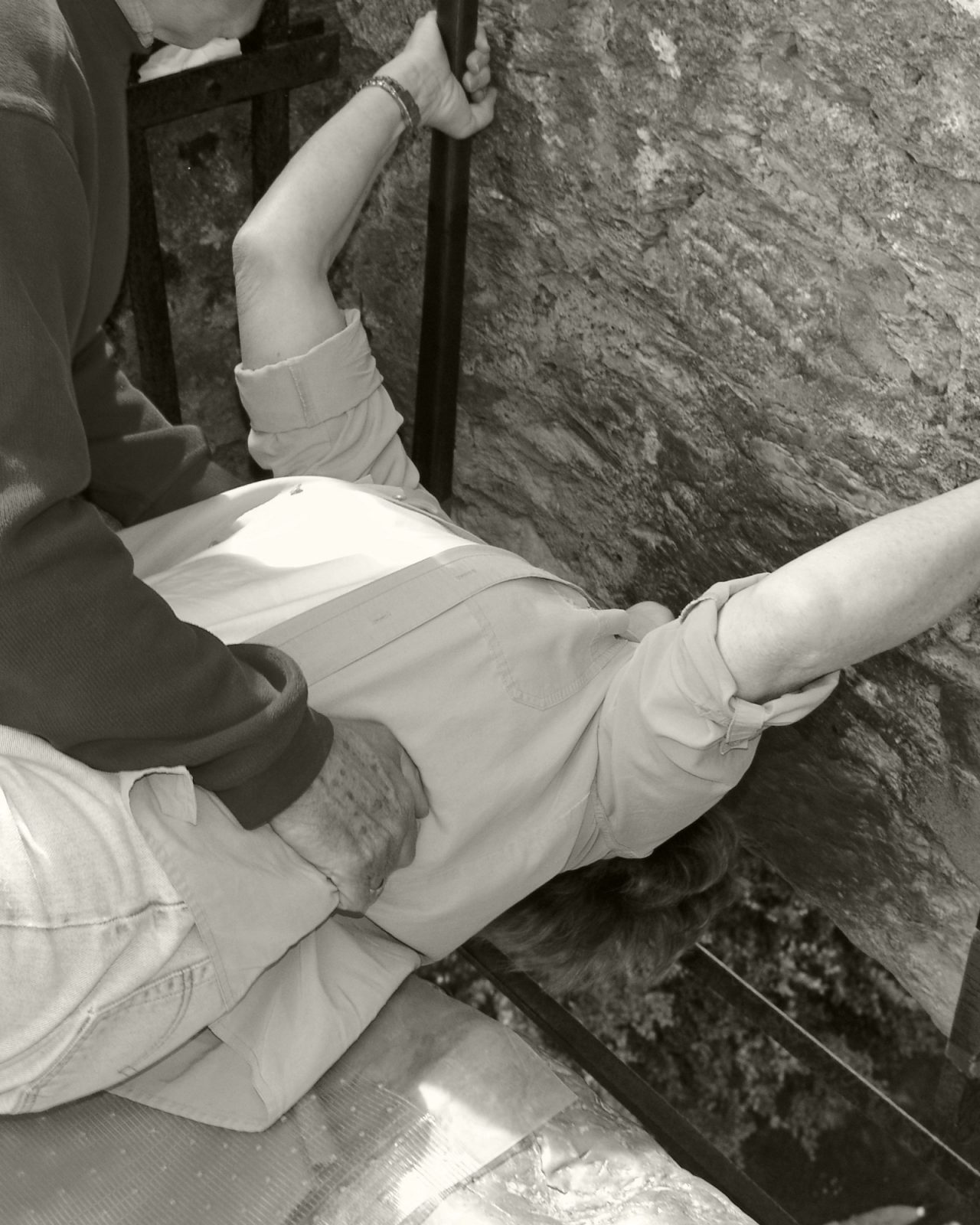 Male holder female while kissing the Blarney Stone