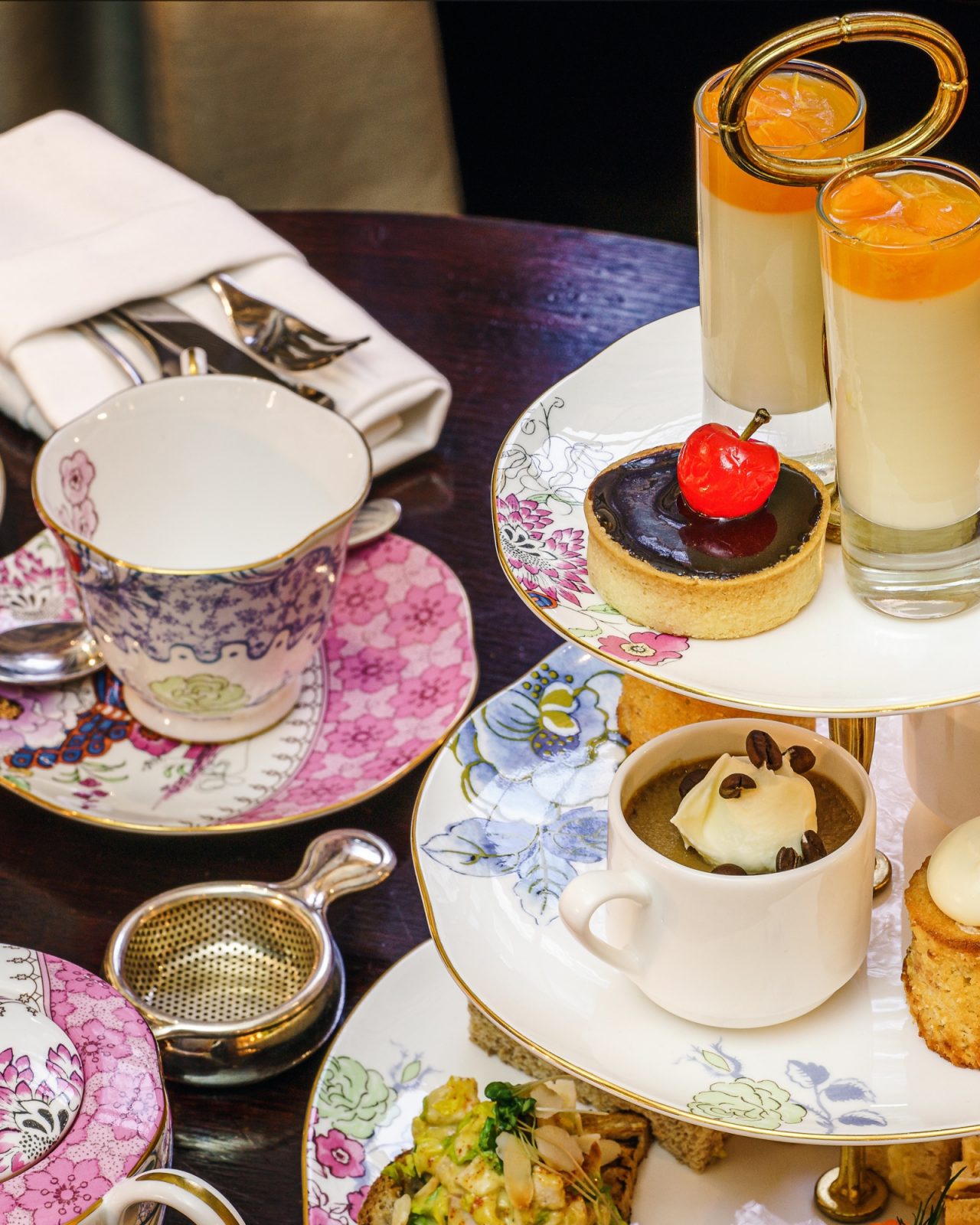 Table with tea cups and desserts set up for a tea party