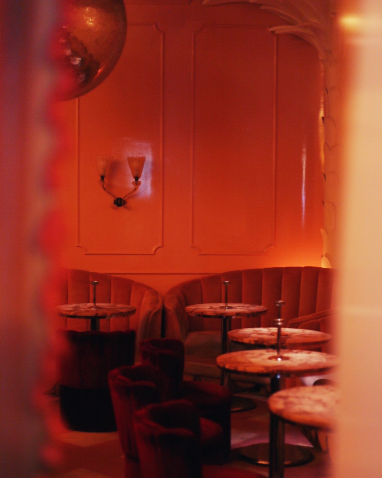 Inside of a Montreal speakeasy with a red hue