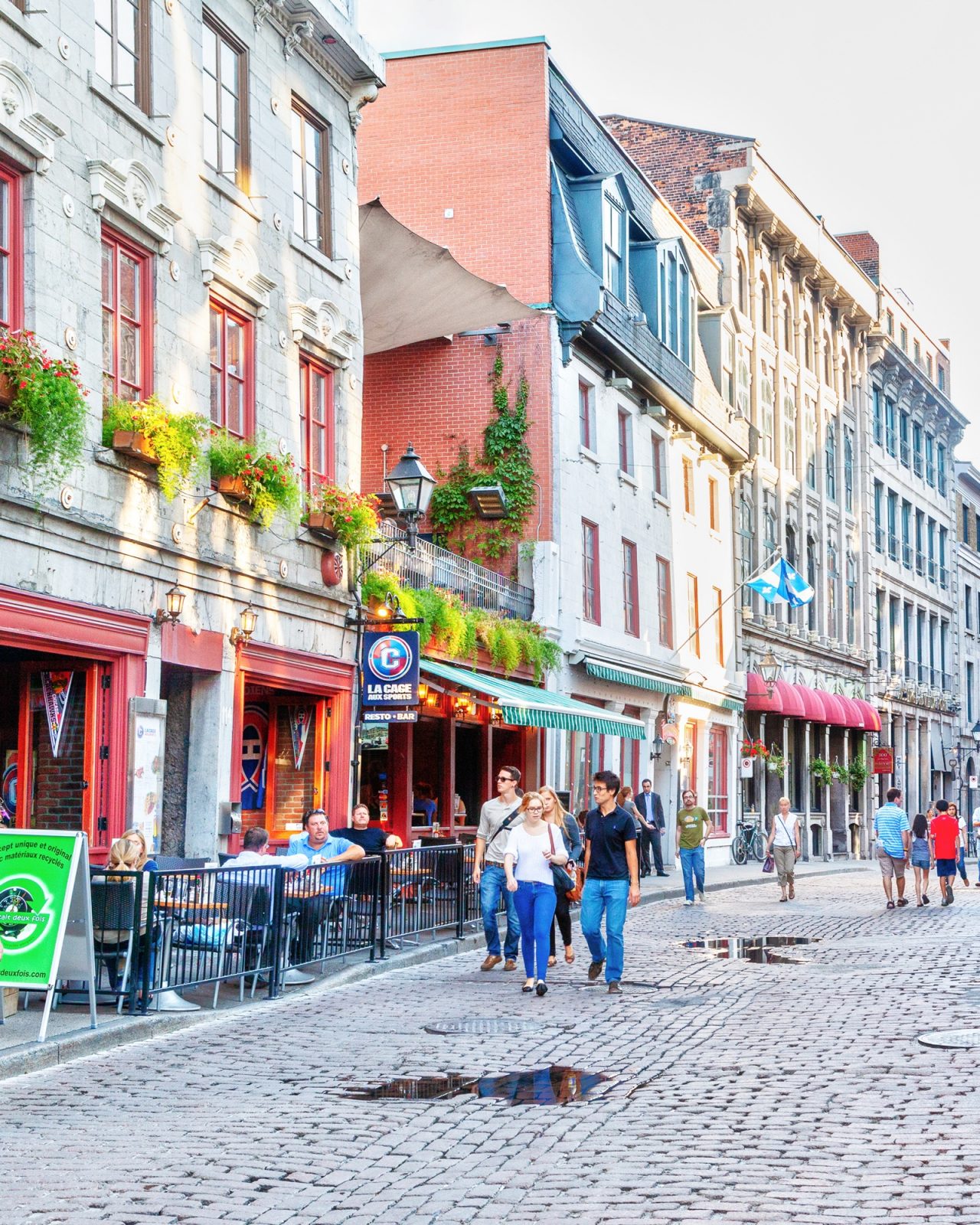 People walking on cobblestone street in Montreal in daytime