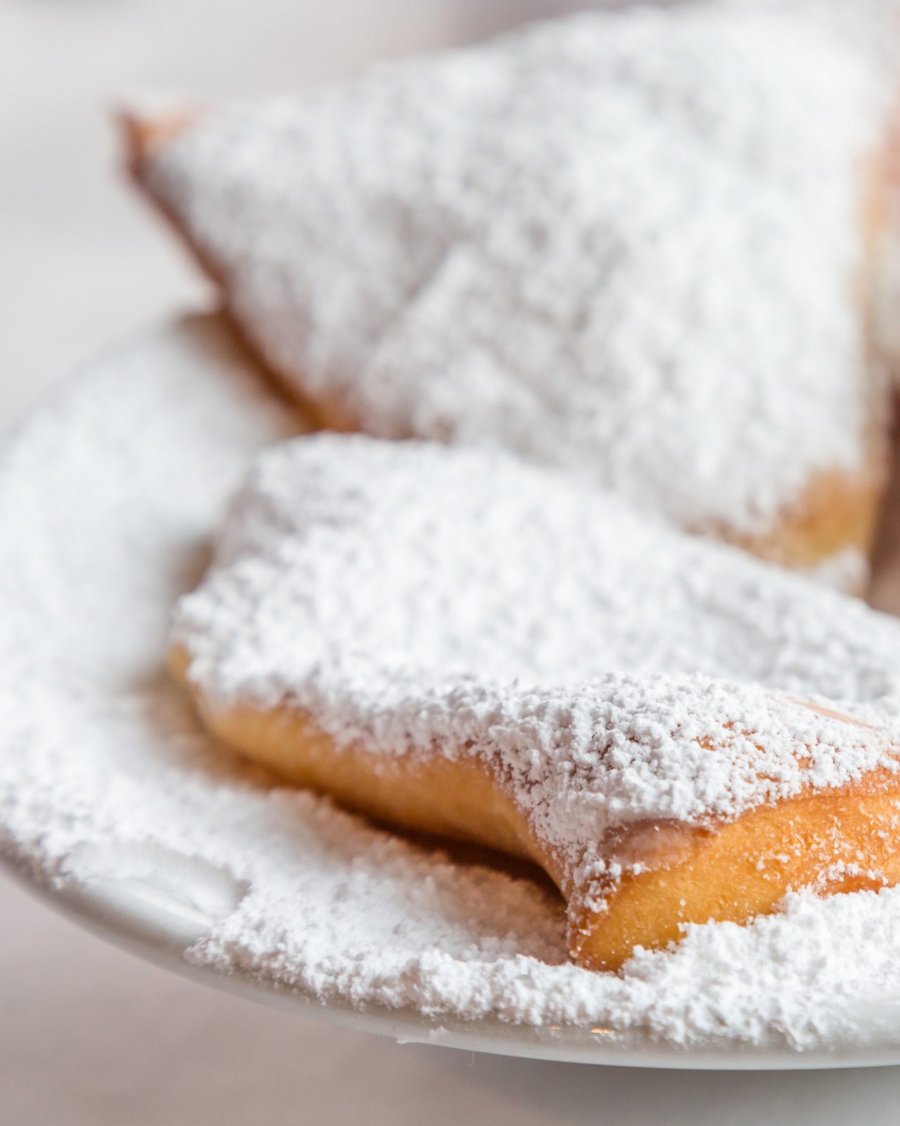 Close up of two beignets on a plate