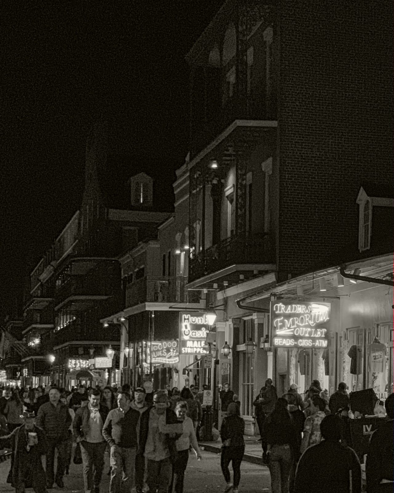 Black and white picture of Bourbon Street at night