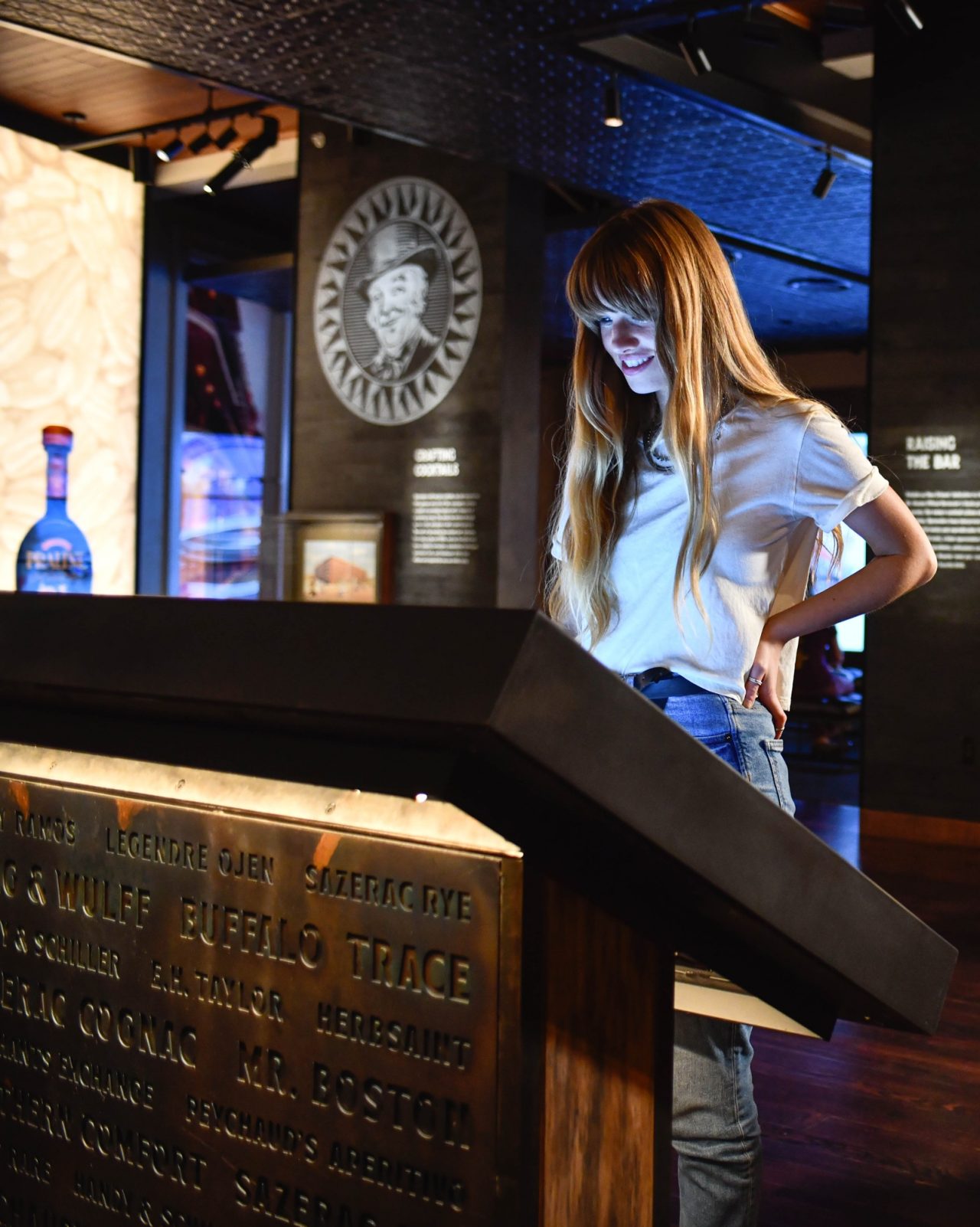 Female interacting with an exhibit at the Sazerac House