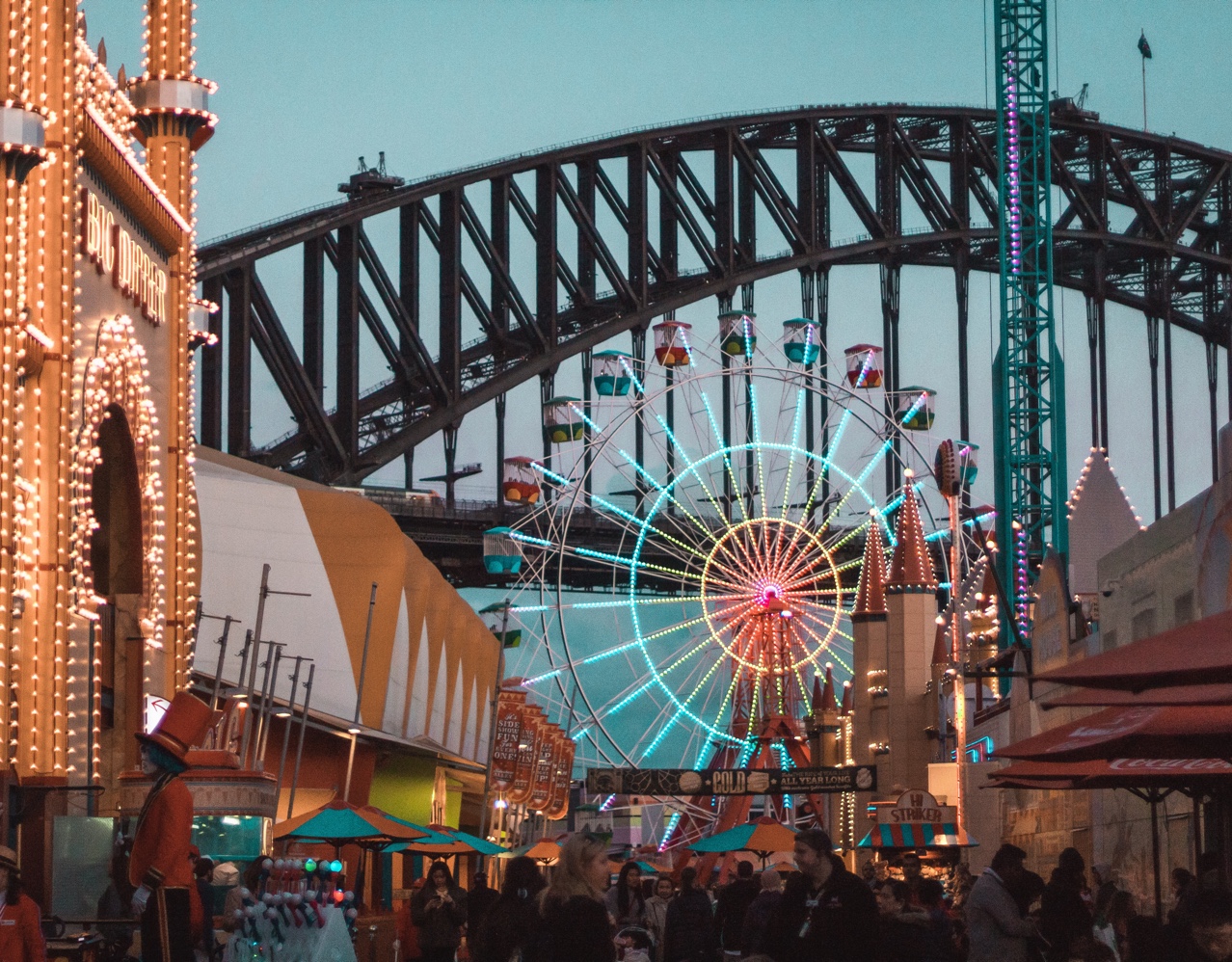 Busy street view of Sydney with Carousel and bridge in the background